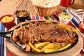 roast beef with seasonings and sliced Ã¢â¬â¹Ã¢â¬â¹barbecue salad served on plate on wooden table Royalty Free Stock Photo